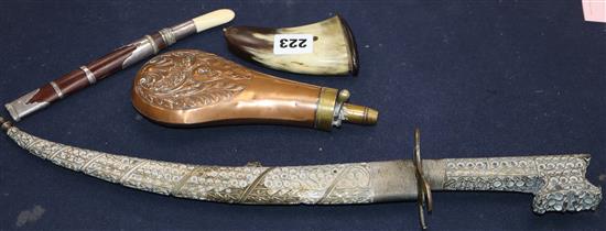 An Eastern plate-mounted dagger with inlaid blade and filigree decoration, a Burmese dha, an embossed copper powder flask and a horn sa